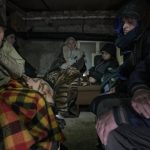 
              A woman cries in the small basement of a house crowded with people seeking shelter from Russian airstrikes, outside the capital Kyiv, Ukraine, Wednesday, March 2, 2022. Russia renewed its assault on Ukraine's second-largest city in a pounding that lit up the skyline with balls of fire over populated areas, even as both sides said they were ready to resume talks aimed at stopping the new devastating war in Europe.(AP Photo/Vadim Ghirda)
            
