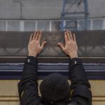 
              Aleksander, 41, presses his palms against the window as he says goodbye to his daughter Anna, 5, on a train to Lviv at the Kyiv station, Ukraine, Friday, March 4. 2022. Aleksander has to stay behind to fight in the war while his family leaves the country to seek refuge in a neighbouring country. (AP Photo/Emilio Morenatti)
            