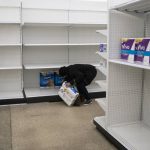 
              FILE - Deanna Butts reaches for one of the last packages of toilet paper at Target in the Tenleytown area of Washington, Tuesday, March 17, 2020. Supplies are restocked as trucks come in but the coronavirus outbreak is causing a current shortage of some items. (AP Photo/Carolyn Kaster, File)
            