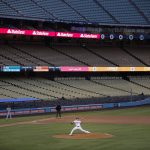 
              FILE - With the seats at Dodger Stadium empty, Los Angeles Dodgers starting pitcher Julio Urias throws to a San Francisco Giants batter during the third inning of a baseball game on July 26, 2020, in Los Angeles. (AP Photo/Jae C. Hong, File)
            