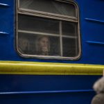 
              Bogdan, 41, says goodbye to his wife Lena, 35, on a train to Lviv at the Kyiv station, Ukraine, Thursday, March 3. 2022. Bogdan is staying to fight while his family is leaving the country to seek refuge in a neighbouring country. (AP Photo/Emilio Morenatti)
            