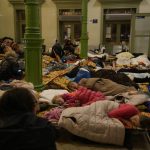 
              Refugees, fleeing from Ukraine, sleep in a shelter designed for women and children at the train station in Przemysl, Poland, Thursday, March 3, 2022. The U.N. refugee agency said Thursday at least 1 million people have fled Ukraine since Russia’s invasion a week ago, an exodus without precedent in this century for its speed. (AP Photo/Markus Schreiber)
            
