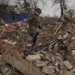 
              Mariya, a local resident, looks for personal items in the rubble of her house, destroyed during fighting between Russian and Ukrainian forces in the village of Yasnohorodka, on the outskirts of Kyiv, Ukraine, Wednesday, March 30, 2022. Russian forces bombarded areas around Kyiv and another city, just hours after pledging to scale back military operations in those places to help negotiations along, Ukrainian authorities said Wednesday. (AP Photo/Vadim Ghirda)
            