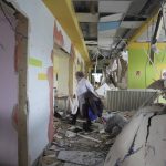 
              A medical worker walks through the hall of a maternity hospital damaged in a shelling attack in Mariupol, Ukraine, Wednesday, March 9, 2022. Associated Press journalists, who have been reporting from inside blockaded Mariupol since early in the war, documented this attack on the hospital and saw the victims and damage firsthand. They shot video and photos of several bloodstained, pregnant mothers fleeing the blown-out maternity ward, medics shouting, children crying. (AP Photo/Evgeniy Maloletka)
            