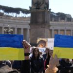 
              Faithful show Ukraine's flags during Pope Francis' Angelus noon prayer in St.Peter's Square, at the Vatican, Sunday, March 13, 2022. (AP Photo/Gregorio Borgia)
            