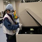 
              A lab technician wearing a pair of smart glasses demonstrates a part of a process to measure levels of tritium in water samples at one of the two laboratories at the Fukushima Daiichi nuclear power plant, run by Tokyo Electric Power Company Holdings (TEPCO), in Okuma town, northeastern Japan, Thursday, March 3, 2022. TEPCO and government officials say tritium, which is not harmful in small amounts, is inseparable from the water, but all other 63 radioactive isotopes selected for treatment can be reduced to safe levels, tested and further diluted by seawater before release. (AP Photo/Hiro Komae)
            