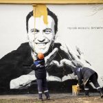 
              FILE - Municipal workers paint over Russia's imprisoned opposition leader Alexei Navalny in St. Petersburg, Russia, April 28, 2021. The worlds on the wall reading "Hero of our time". (AP Photo, File)
            