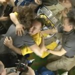 
              In this frame grab from video provided by Roscosmos, the crew of the International Space Station welcomes three Russian cosmonauts, dressed in yellow, after the new arrivals docked, Friday, March 18, 2022. The cosmonauts emerged from the Soyuz capsule wearing yellow flight suits with blue stripes, the colors of the Ukrainian flag. (Roscosmos via AP)
            