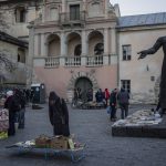 
              People roam around a used-books street market in downtown Lviv, Western Ukraine, Saturday, March 19, 2022. Lviv has been a refuge since the war began nearly a month ago, the last outpost before Poland and host to hundreds of thousands of Ukrainians streaming through or staying on. (AP Photo/Bernat Armangue)
            