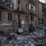 
              A resident carries a suitcase with his belongings after his building was heavily damaged by bombing in Kyiv, Ukraine, Friday, March 18, 2022. Russian forces pressed their assault on Ukrainian cities Friday, with new missile strikes and shelling on the edges of the capital Kyiv and the western city of Lviv, as world leaders pushed for an investigation of the Kremlin’s repeated attacks on civilian targets, including schools, hospitals and residential areas. (AP Photo/Felipe Dana)
            