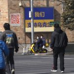 
              A sign partially covered up after being defaced is seen outside the Canadian Embassy showing the Ukrainian flag with the words "We support Ukraine" on Thursday, March 3, 2022, in Beijing. China on Thursday denounced a report that it asked Russia to delay invading Ukraine until after the Beijing Winter Olympics as "fake news" and a "very despicable" attempt to divert attention and shift blame over the conflict. (AP Photo/Ng Han Guan)
            