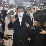 
              Lee Jae-myung, center, the presidential candidate of the ruling Democratic Party, arrives his house in Seongnam, South Korea, Wednesday, March 9, 2022. South Koreans were voting for a new president Wednesday, with an outspoken liberal ruling party candidate and a conservative former prosecutor considered the favorites in a tight race that has aggravated domestic divisions. (Hong Ji-won/Yonhap via AP)
            