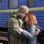 
              FILE - A couple embrace prior to the woman boarding a train carriage leaving for western Ukraine, at the railway station in Kramatorsk, eastern Ukraine, Sunday, Feb. 27, 2022. The United Nations says that more than 3.6 million people have fled Ukraine since the war started exactly one month ago Thursday in what is the biggest movement of people in Europe since World War II. Unprepared, most refugees believed they would soon be back home. That hope is waning now. (AP Photo/Andriy Andriyenko, File)
            