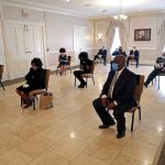 
              FILE - Friends and family of Larry Hammond who were among only 10 mourners allowed, sit in chairs spaced for social distancing, during his funeral at Boyd Funeral Home in New Orleans on April 22, 2020. (AP Photo/Gerald Herbert, File)
            