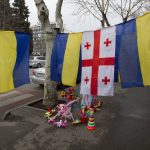 
              Ukrainian and Georgian national flags are displayed for sale in a street near the Georgian Parliament prior to an action against Russia's attack on Ukraine in Tbilisi, Russia, Thursday, March 3, 2022. (AP Photo/Shakh Aivazov)
            