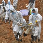 
              In this photo released by Xinhua News Agency, rescuers carry a piece of plane wreckage at the site of Monday's plane crash in Tengxian County, southern China's Guangxi Zhuang Autonomous Region, Friday, March 25, 2022. Construction excavators dug into the crash site Saturday in the search for wreckage, remains and the second black box from a China Eastern 737-800 that nosedived into a mountainside in southern China this week with 132 people on board. (Zhou Hua/Xinhua via AP)
            