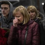 
              A displaced Ukrainian woman cries as she waits to get on a train to Poland, at the Lviv railway station, in Lviv, western Ukraine, Thursday, March 3, 2022. Russia’s invasion of Ukraine has forced more than a million people to flee their homeland in just a week. (AP Photo/Bernat Armangue)
            