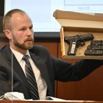 Louisville Metro Police Officer Matt Gelhausen holds up the evidence box contains the firearm used by Brett Hankison during prosecution's questioning Tuesday, March 1, 2022, in Louisville, Ky.  Hankison is currently on trial, charged with wanton endangerment for shooting through Breonna Taylor's apartment into the home of her neighbors during botched police raid that killed Taylor. (AP Photo/Timothy D. Easley, Pool)