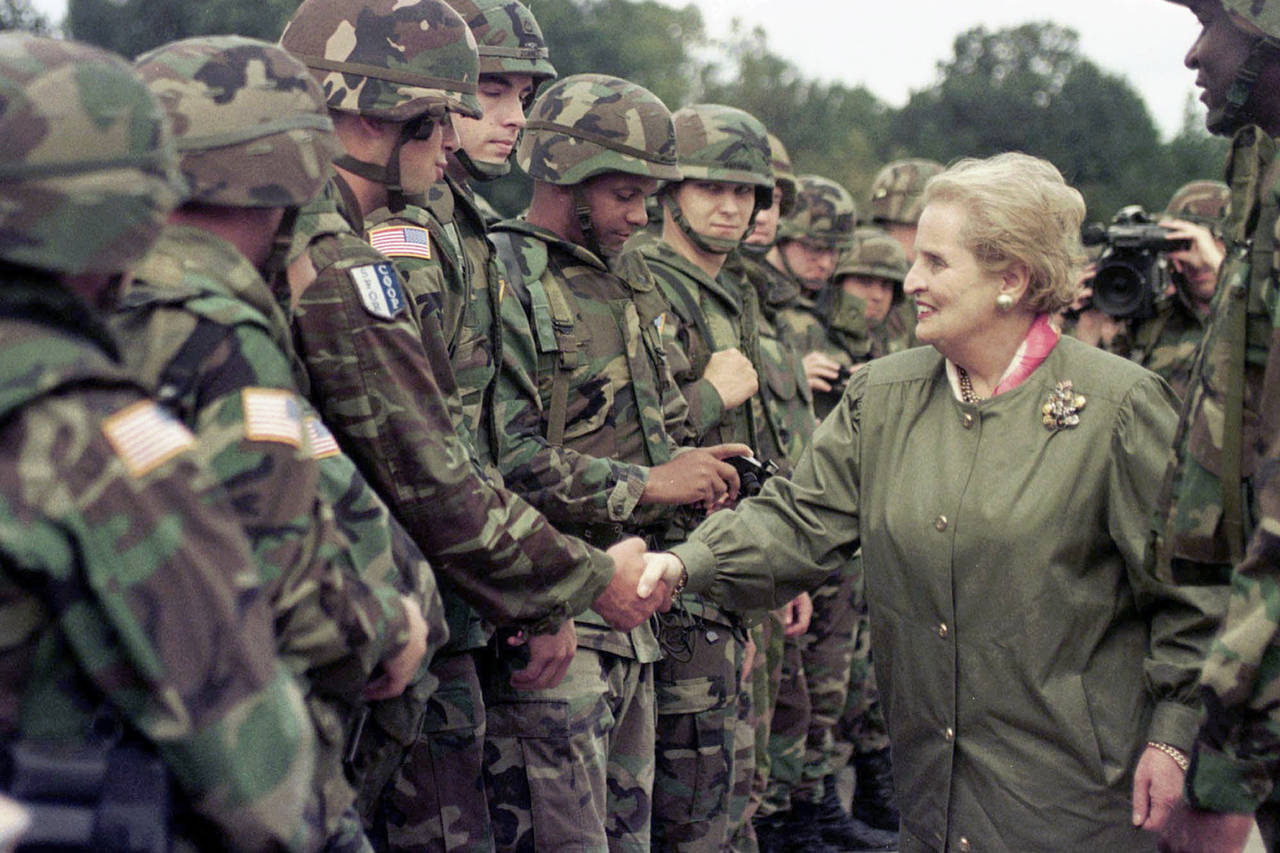 FILE - U.S. Secretary of State Madeleine Albright shakes hands with U..S soldiers during her visit ...