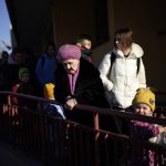 
              A Ukrainian woman stands as other refugees arrive from Lviv to Przemysl train station, southeastern Poland, on Friday, March 11, 2022. Thousands of people have been killed and more than 2.3 million have fled the country since Russian troops crossed into Ukraine on Feb. 24. (AP Photo/Daniel Cole)
            