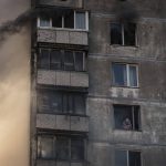 
              An elderly resident waits to be rescued by firefighters after the apartment building was hit by shelling in Kyiv, Ukraine, Tuesday, March 15, 2022. (AP Photo/Felipe Dana)
            