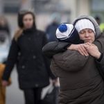 
              Refugees fleeing Ukraine reunite at the border crossing in Medyka, Poland, Monday, March 7, 2022. Russia announced yet another limited cease-fire and the establishment of safe corridors to allow civilians to flee some besieged Ukrainian cities Monday. But the evacuation routes led mostly to Russia and its ally Belarus, drawing withering criticism from Ukraine and others. (AP Photo/Visar Kryeziu)
            