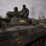 
              Ukrainian servicemen ride atop tanks in the town of Trostsyanets, Ukraine, Monday, March 28, 2022. Trostsyanets was recently retaken by Ukrainian forces after being held by Russians since the early days of the war. (AP Photo/Felipe Dana)
            