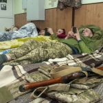 
              Ukrainian servicemen have a rest in Kharkiv, Ukraine, Tuesday, March 22, 2022. (AP Photo/Andrew Marienko)
            