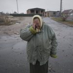 
              A woman cries outside houses damaged by a Russian airstrike, according to locals, in Gorenka, outside the capital Kyiv, Ukraine, Wednesday, March 2, 2022. Russia renewed its assault on Ukraine's second-largest city in a pounding that lit up the skyline with balls of fire over populated areas, even as both sides said they were ready to resume talks aimed at stopping the new devastating war in Europe. (AP Photo/Vadim Ghirda)
            
