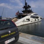 
              An Italian Finance Police car is parked in front of the yacht "Lady M", owned by Russian oligarch Alexei Mordashov, docked at Imperia's harbor, Italy, Saturday, March 5, 2022. European governments are moving against Russian oligarchs to pressure Russian President Vladimir Putin to back down on his war in Ukraine, seizing superyachts and other luxury properties from billionaires on sanctions lists. (AP Photo/Antonio Calanni)
            