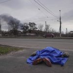 
              The dead body of a person lies covered in the street in Mariupol, Ukraine, Monday, March 7, 2022. (AP Photo/Evgeniy Maloletka)
            