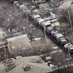 
              In this photo taken from video released by the Russian Defense Ministry Press Service on Thursday, March 3, 2022, a view from the window of a Russian military helicopter as it flies over an undisclosed location in Ukraine. (Russian Defense Ministry Press Service via AP)
            