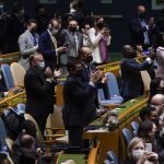 
              United Nations members stand up and applaud after a vote on a resolution concerning the Ukraine during an emergency meeting of the General Assembly at United Nations headquarters, Wednesday, March 2, 2022. (AP Photo/Seth Wenig)
            