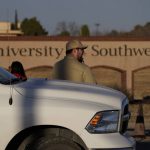 
              A security guard stands at the entrance to the University of the Southwest, Wednesday, March 16, 2022, in Hobbs, N.M. Students and a golf coach from the school were killed in a head-on collision in West Texas on Tuesday. (AP Photo/John Locher)
            