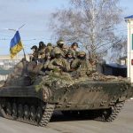 
              Ukrainian soldiers ride a tank through the town of Trostsyanets, some 400 km eastern of capital Kyiv, Ukraine, Monday, March 28, 2022. The more than month-old war has killed thousands and driven more than 10 million Ukrainians from their homes — including almost 4 million from their country. (AP Photo/Efrem Lukatsky)
            