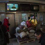 
              Ukrainian volunteers sort donated foods for later distribution to the local population while Ukrainian President Volodymyr Zelenskiy appears on television in Lviv, western Ukraine, Wednesday, March 2, 2022. Russia renewed its assault Wednesday on Ukraine’s second-largest city in a pounding that lit up the skyline with balls of fire over populated areas, even as Moscow said it would be ready to resume talks aimed at stopping the new devastating war in Europe. (AP Photo/Bernat Armangue)
            