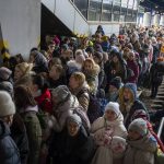 
              People crowd as they try to get on a train to Lviv at the Kyiv station, Ukraine, Friday, March 4. 2022. Ukrainian men have to stay to fight in the war while women and children are leaving the country to seek refuge in a neighboring country. (AP Photo/Emilio Morenatti)
            