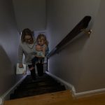 
              Tara Carpenter carries her daughter, Alyssa Carpenter, 2, and a box of diapers upstairs at their home in Haymarket, Va., Friday, Jan. 28, 2022. Alyssa has had COVID-19 twice and suffers long-term symptoms. She is part of a NIH-funded multi-year study at Children's National Hospital to look at impacts of COVID-19 on children's physical health and quality of life. (AP Photo/Carolyn Kaster)
            