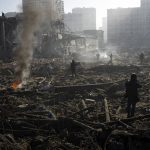 
              People gather amid the destruction caused after shelling of a shopping center, in Kyiv, Ukraine, Monday, March 21, 2022. (AP Photo/ (AP Photo/Rodrigo Abd)
            