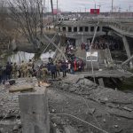 
              People cross on an improvised path under a bridge that was destroyed by a Russian airstrike, while fleeing the town of Irpin, Ukraine, Saturday, March 5, 2022. What looked like a breakthrough cease-fire to evacuate residents from two cities in Ukraine quickly fell apart Saturday as Ukrainian officials said shelling had halted the work to remove civilians hours after Russia announced the deal. (AP Photo/Vadim Ghirda)
            