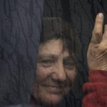 
              A woman evacuated from the town of Shevchenkove by the Ukrainian government due to heavy fighting against Russia, waits inside a bus upon arrival in Brovary, on the outskirts of Kyiv, Ukraine, Tuesday, March 29, 2022. (AP Photo/Rodrigo Abd)
            