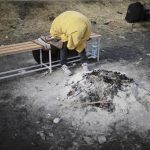 
              A man sits by the remains of a bonfire after fleeing from the Ukraine near the border crossing in Medyka, Poland, Tuesday, March 1, 2022. Russian shelling pounded civilian targets in Ukraine's second-largest city, Kharkiv, Tuesday and a 40-mile convoy of tanks and other vehicles threatened the capital — tactics Ukraine's embattled president said were designed to force him into concessions in Europe's largest ground war in generations. (AP Photo/Markus Schreiber)
            