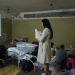 
              A woman holds her newborn child in the basement of a maternity hospital converted into a medical ward and used as a bomb shelter during an air raid alert, in Kyiv, Ukraine, Wednesday, March 2, 2022. Russian forces have escalated their attacks on crowded cities in what Ukraine's leader called a blatant campaign of terror. (AP Photo/Efrem Lukatsky)
            