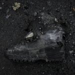 
              A charred boot lies on the ground next to a destroyed Russian tank in Irpin, on the outskirts of Kyiv, Ukraine, Wednesday, March 9, 2022. A Russian airstrike devastated a maternity hospital Wednesday in the besieged port city of Mariupol amid growing warnings from the West that Moscow's invasion is about to take a more brutal and indiscriminate turn. (AP Photo/Vadim Ghirda)
            