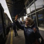 
              Natalia, 57, says goodbye to her daughter and grandson on a train to Lviv at the Kyiv station, Ukraine, Thursday, March 3. 2022. (AP Photo/Emilio Morenatti)
            