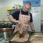 
              A volunteer cooks food for Ukrainian servicemen in Kharkiv, Ukraine, Tuesday, March 22, 2022. (AP Photo/Andrew Marienko)
            
