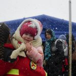 
              An employee from the Emergency Situations Department holds the baby of a refugee fleeing the conflict from neighbouring Ukraine at the Romanian-Ukrainian border, in Siret, Romania, Thursday, March 10, 2022. (AP Photo/Andreea Alexandru)
            