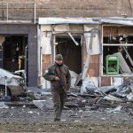 
              Ukrainian soldier passes at a destroyed building after a Russian bombing attack in Kyiv, Ukraine, Monday, March 14, 2022. (AP Photo/Efrem Lukatsky)
            