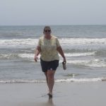 
              FILE: Suzanne Hornick walks from the surf in Ocean City N.J. on July 8, 2021. She is a leader of a residents group that opposes three offshore wind energy projects approved for the ocean off Ocean City. On Monday, March 7, 2022, she and many others voiced strong opposition to the project in a public hearing that could be a glimpse at the future of efforts to connect offshore power projects to the shoreline. (AP Photo/Wayne Parry, FILE)
            