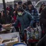 
              Displaced people line up for food rations outside Lviv railway station, in Lviv, western Ukraine, Thursday, March 3, 2022. Russia’s invasion of Ukraine has forced more than a million people to flee their homeland in just a week.  (AP Photo/Bernat Armangue)
            